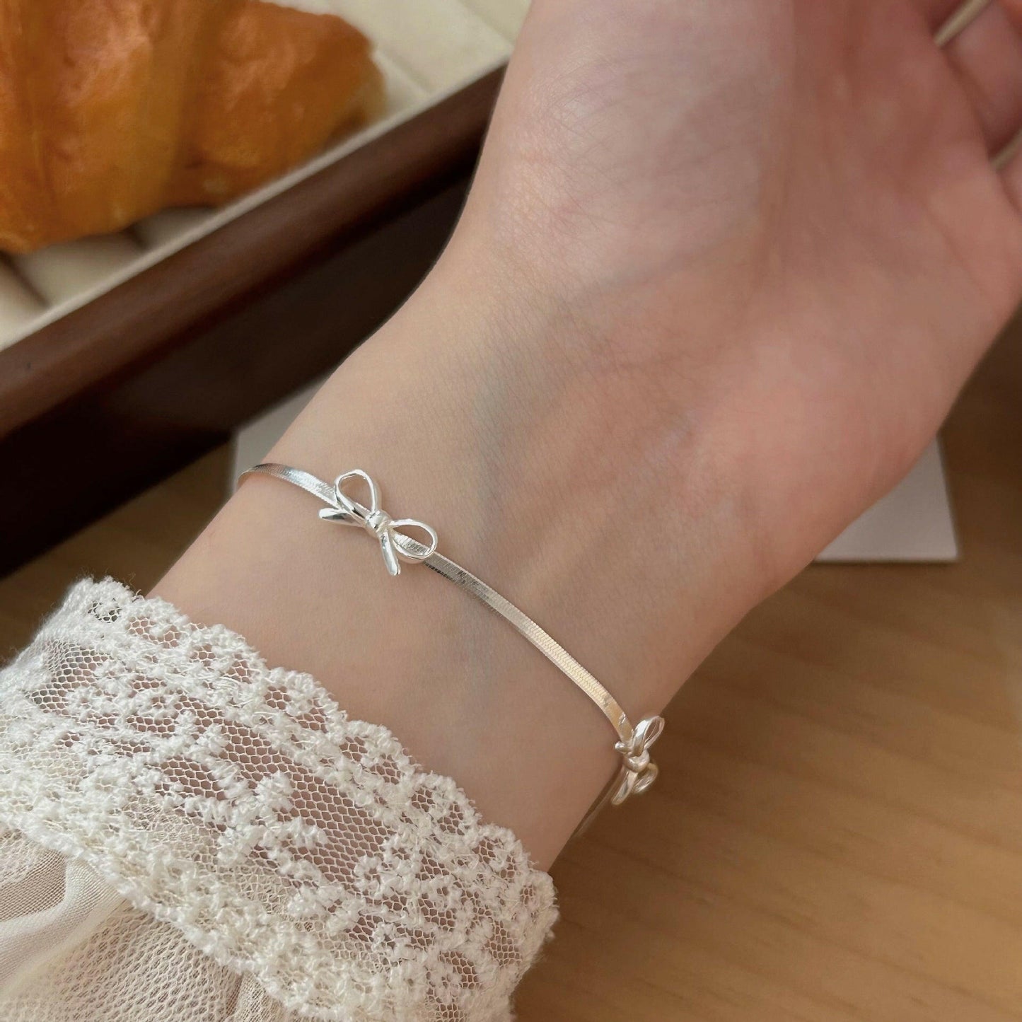 holding hengxin s925 sterling silk bow snake bone chain necklace women 2024 explosion niche senior smart light luxury clasia bone chain