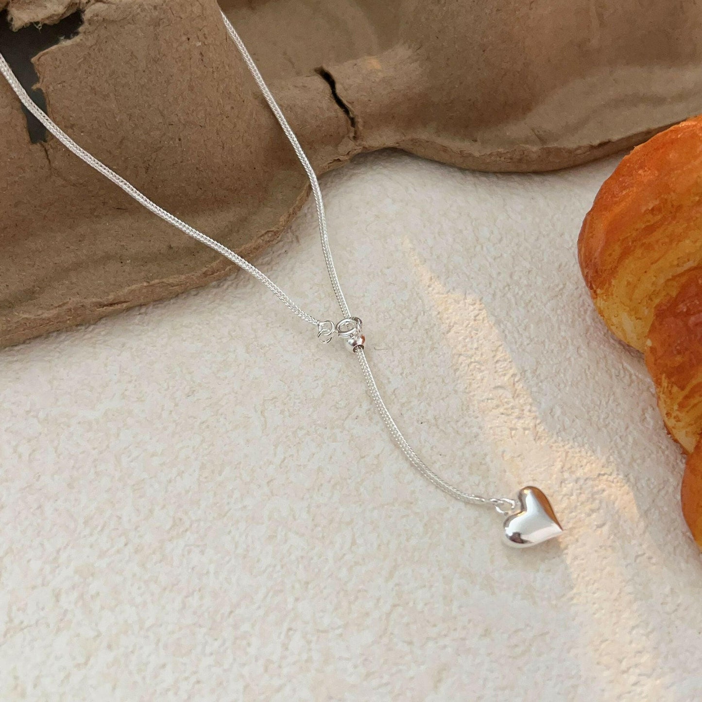 holding the heng s925 sterling silver love stretch necklace female niche design sensor clavicle chain 2024 korean version of the new tide