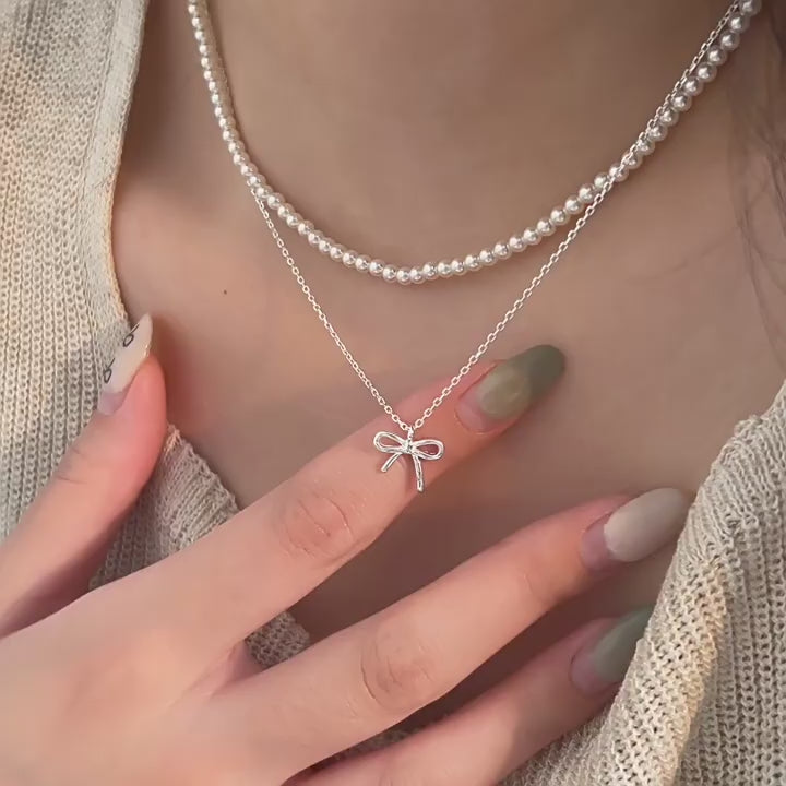 holding s925 sterling silver light luxury pearl bow dual layer stack wearing necklace female korean summer versatile clavicle chain